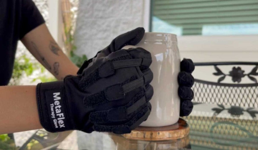 MetaFlex Gloves holding coffee cup