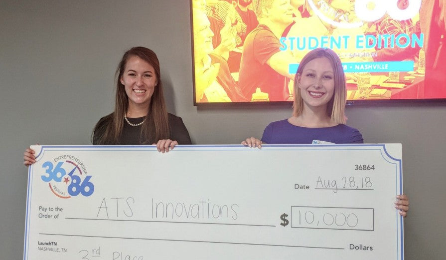 Tea Phillips holding check for ATS Innovations